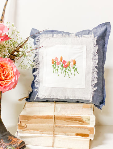 Olivewood’s 12” floral embroidered pillow.